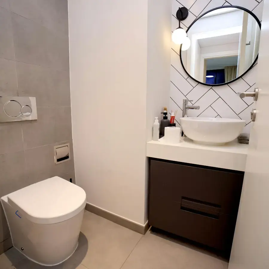 Modern remodeled bathroom in Greensboro featuring sleek tiles and glass shower enclosure